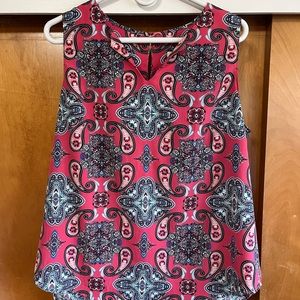 Pink patterned sleeveless blouse. Great for business and casual attire.
